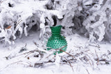 Underlay Dark Green Hobnail Jug in a snowy forest