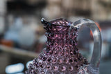 Underlay Violet Hobnail Jug with a blurred background